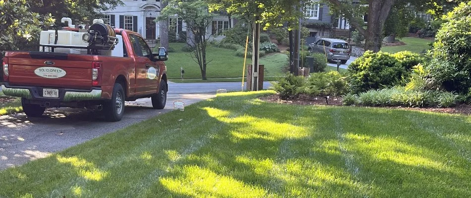 A red truck beside a green lawn in Watkinsville, GA.